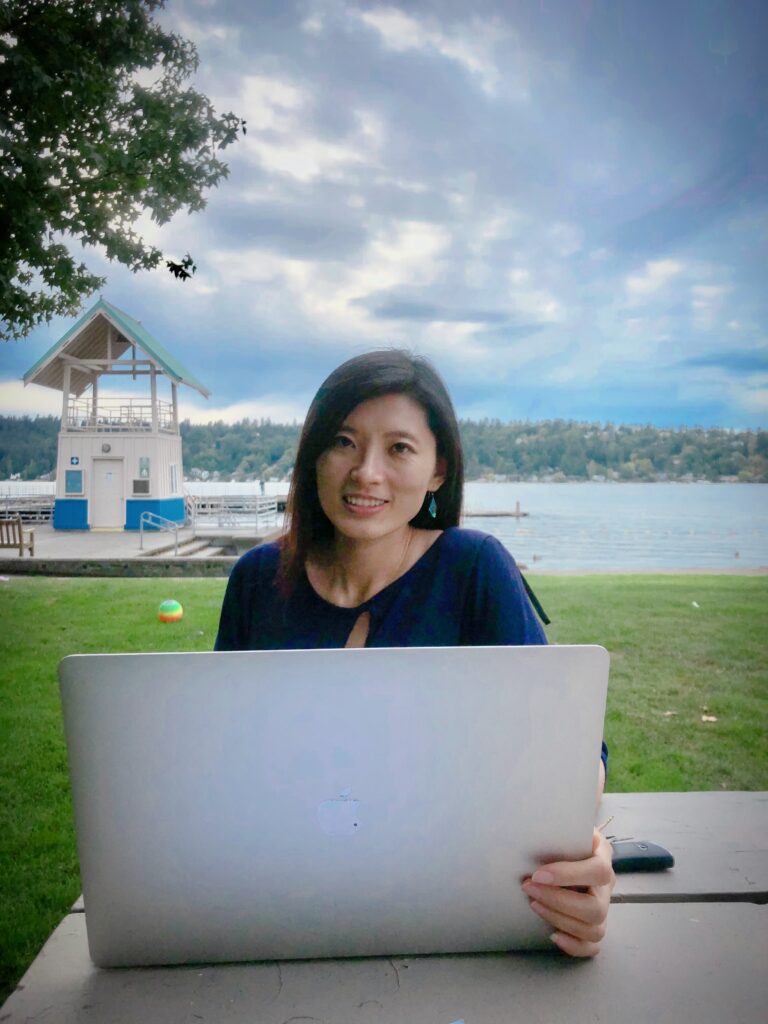 Career and Relationship Coach standing in front of a beautiful lake