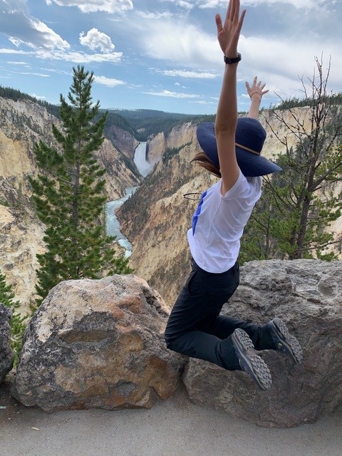 Coach Sixu leaps joyfully in the air, expressing freedom and individuality with the words "free to be you" on canyon.